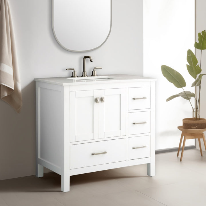 A modern bathroom features the Vanea 36 inch Bathroom Vanity in White with a white quartz top, sink, silver faucet, and metal-handled cabinets.