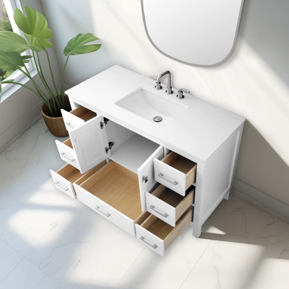 The Vanea 48 inch Bathroom Vanity in White with White Quartz Top is shown with open drawers and cabinet doors revealing wooden interiors, while sunlight from a nearby window highlights the vanity on a tiled floor.