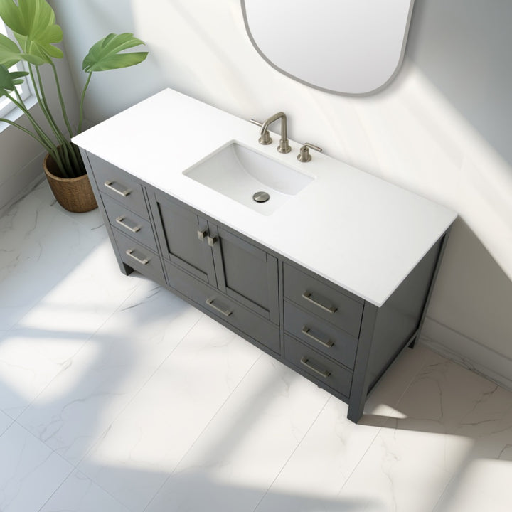 The Vanea 60 inch Single Bathroom Vanity in Gray with White Quartz Top features a built-in sink, silver handles, and gray cabinets, complemented by a white tiled floor, potted plant, and wall mirror nearby.