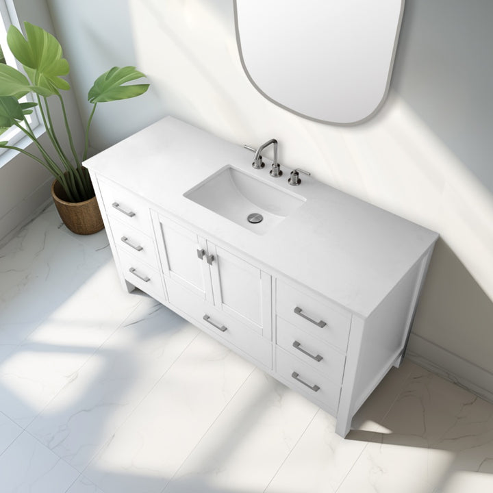 The Vanea 60 inch Single Bathroom Vanity in White with White Quartz Top features a modern design, built-in sink, chrome faucet, drawers, and cabinet doors. Sunlight streams past a frameless mirror onto the tiled floor where a potted plant sits nearby.