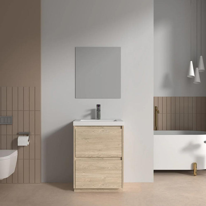 Modern minimalist bathroom featuring the Arvia 24 inch Bathroom Vanity with Sink, a rectangular mirror, wall-mounted toilet, toilet paper holder, and a white bathtub with gold fixtures in neutral beige and white tones.