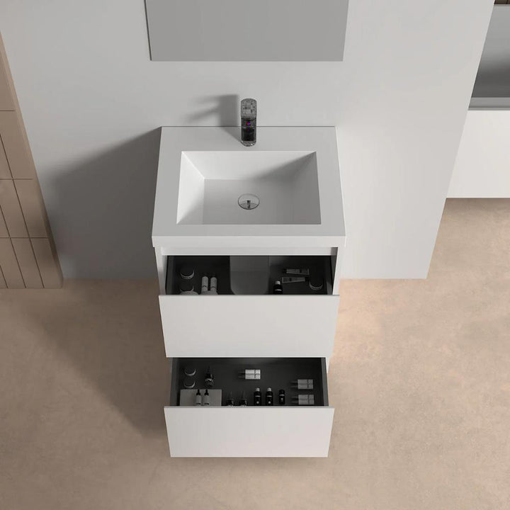 The Arvia 24 inch Bathroom Vanity with Sink features a modern white design with two open drawers for organized toiletries, set against a beige floor and white wall.