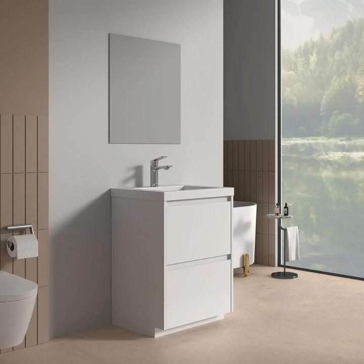 A modern bathroom features the Arvia 24 inch Bathroom Vanity with Sink, a rectangular mirror, wall-mounted toilet, toilet paper holder, and a large window overlooking a tree-lined lake. Ample natural light enhances the minimalist design.
