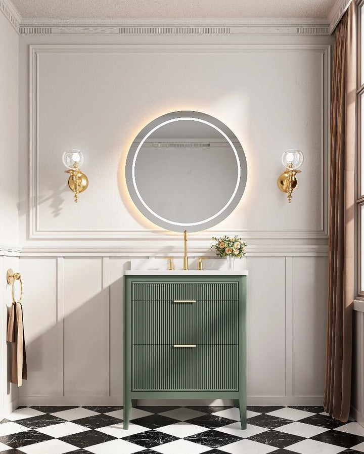 A stylish bathroom features the Aveline 30 Inch Freestanding Bathroom Vanity With Top, a round backlit mirror, gold fixtures, wall sconces, a black-and-white checkered floor, and a large window with brown curtains streaming in natural light.