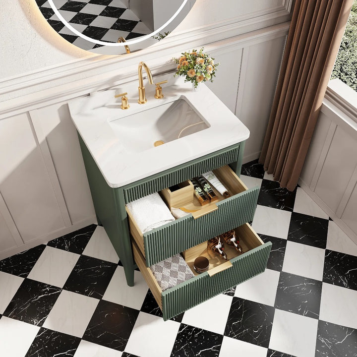 The Aveline 30 Inch Freestanding Bathroom Vanity With Top features a white sink, gold faucet, and green ribbed drawers for storage. It stands on a black and white checkered tile floor next to a window with brown curtains.
