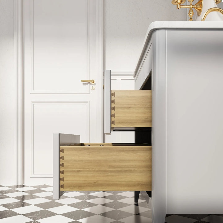 A close-up side view of the Aveline 36 Inch Freestanding Bathroom Vanity With Top shows two open wooden drawers, black-and-white checkered floor tiles, and a white door with a gold handle in the background.