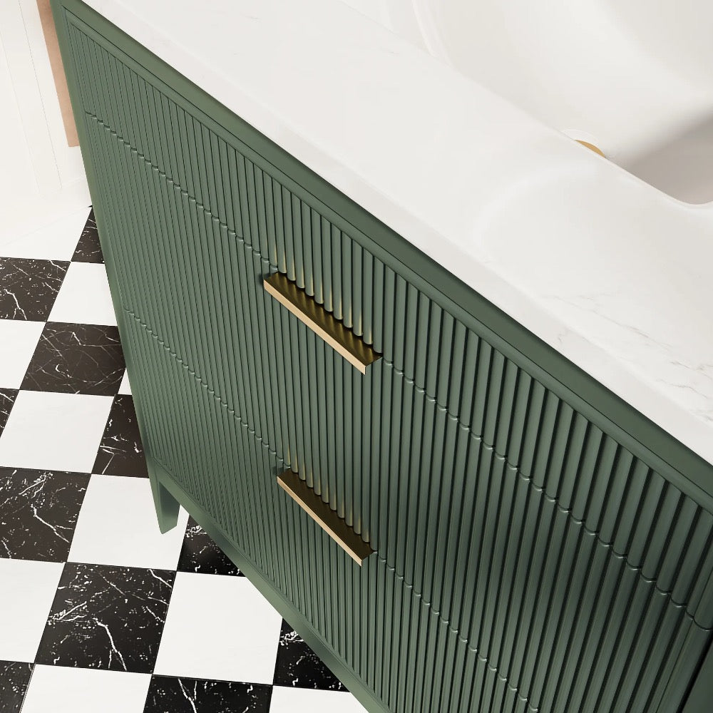 The Aveline 36 Inch Freestanding Bathroom Vanity With Top features a green finish with vertical grooves, gold handles, and a white marble countertop. The floor displays black and white checkered tile with marble-textured accents.
