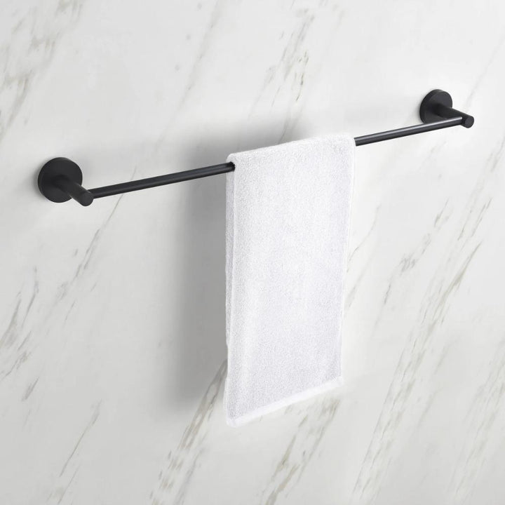 A white hand towel hangs neatly on a black Halo Bathroom Towel Bar, which is mounted on a white marble-patterned wall.