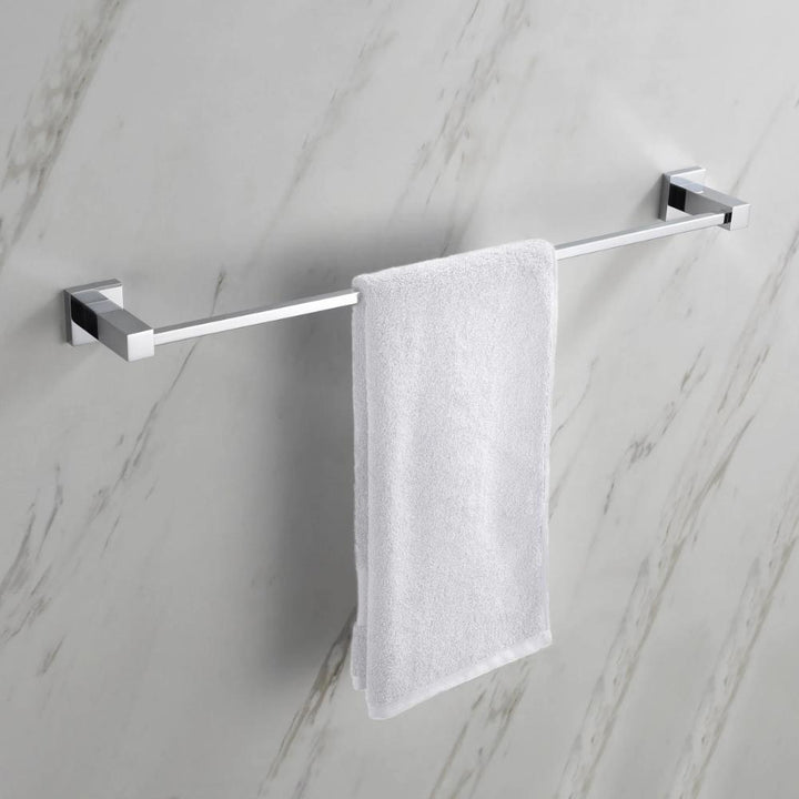 A white towel neatly hangs on the modern Quadra Bathroom Towel Bar, which is mounted on a light-colored marble wall.