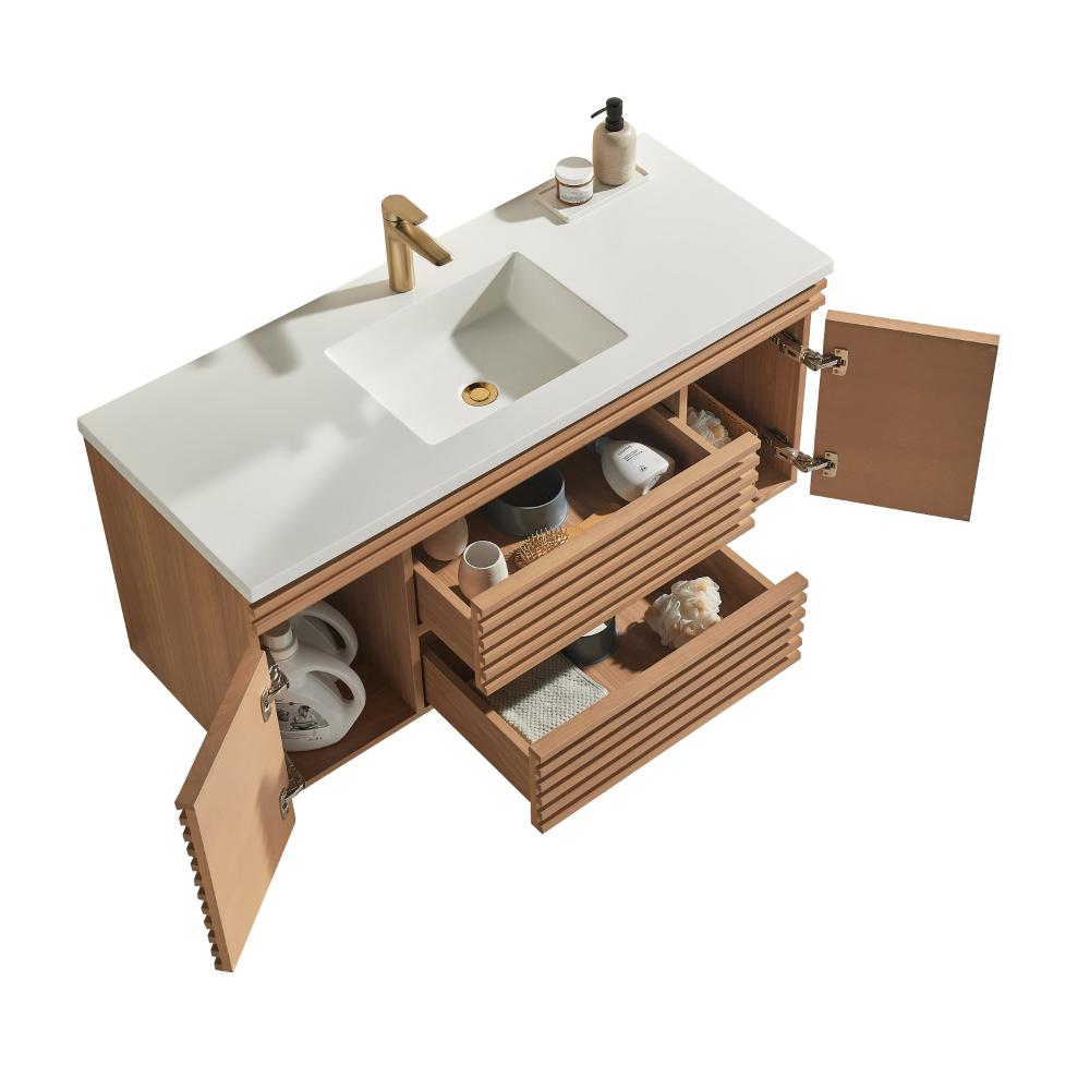 The Linea 48 Inch Wall Mounted Bathroom Vanity features a modern white countertop, gold faucet, built-in sink, and open wooden cabinets and drawers displaying towels, toiletries, and stylish decor items.