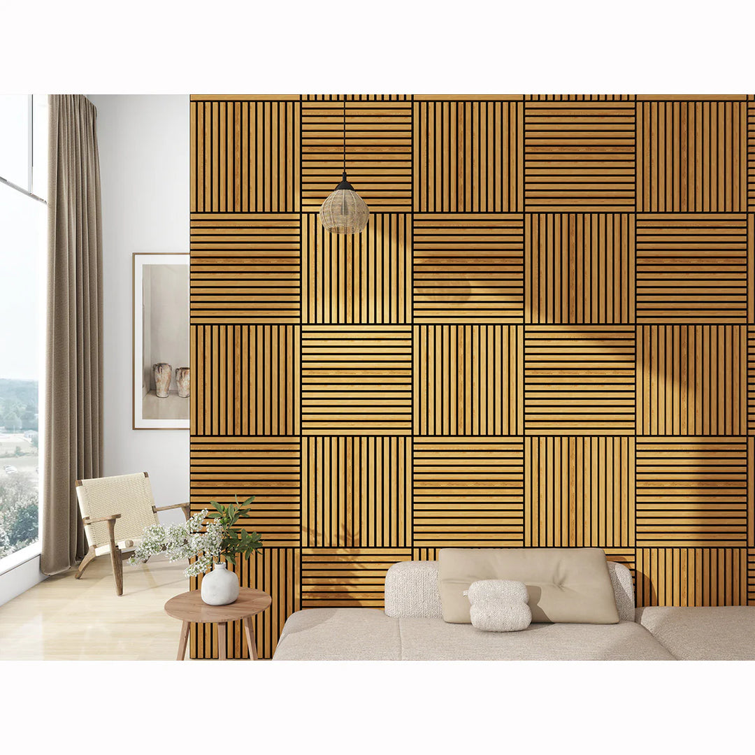 A modern living room features a statement wall with Acoustic Interior Wall Panels in alternating slat directions, a beige sofa with cushions, a round wooden table, a chair, and a tall window with curtains.