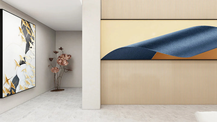 A modern interior with light walls and floors features a large abstract artwork on the left, a decorative metal flower sculpture in the corner, and another abstract piece mounted on a 3D Interior Wall Panel.
