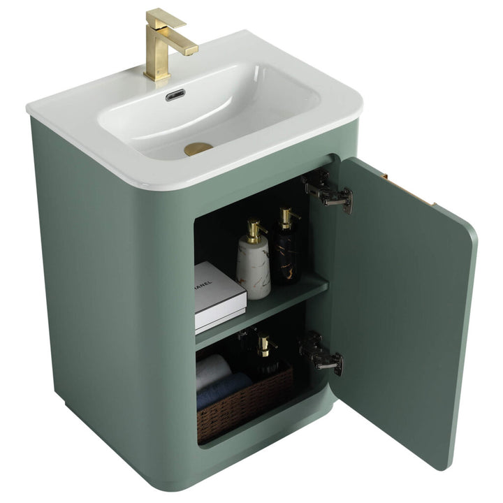 The Shireplace 24 Inch Bathroom Vanity With Sink showcases a modern green finish with an open-door cabinet. It includes a white top, gold faucet, and offers storage for items like bottles, a book, and a basket for stylish organization.