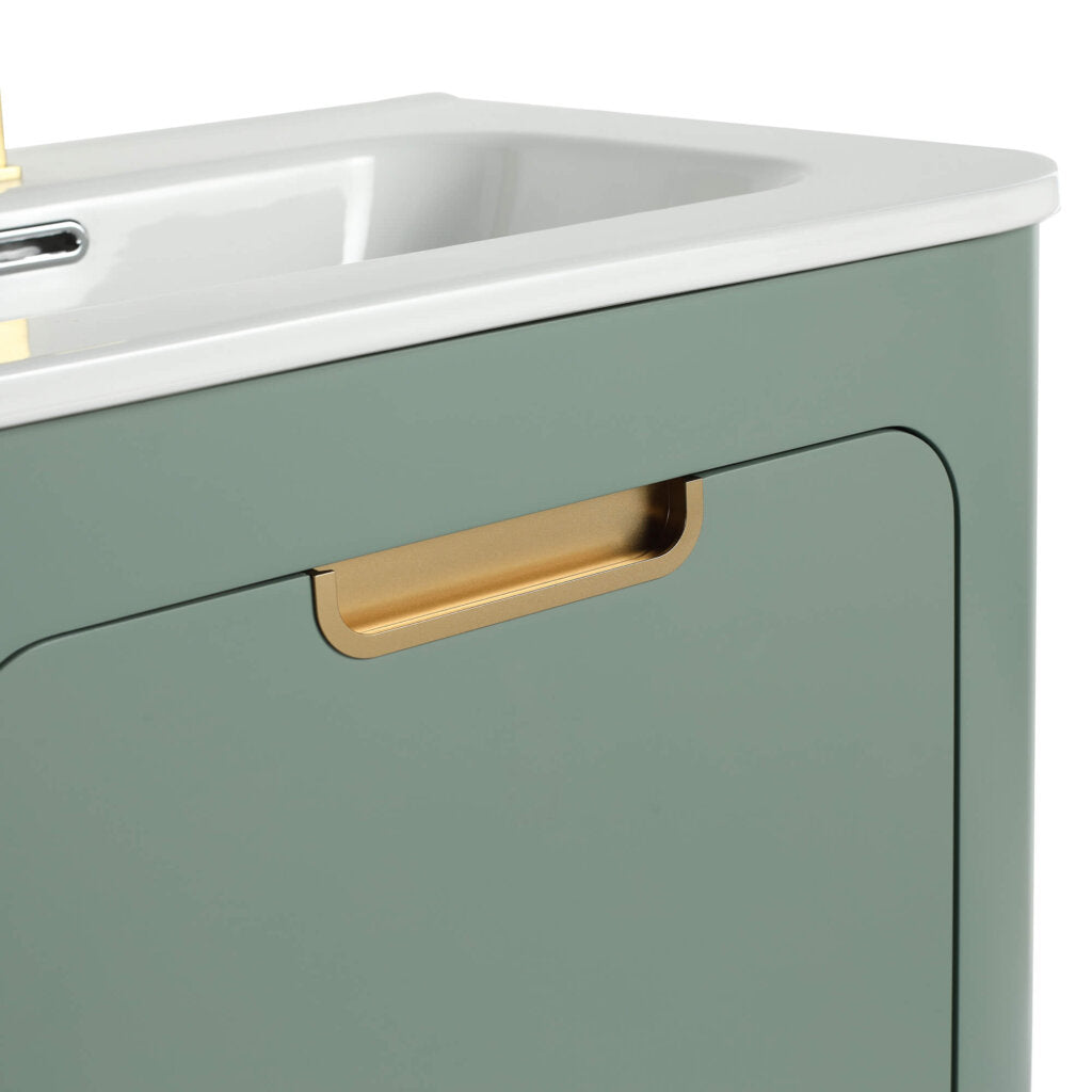 The modern green Shireplace 24 Inch Bathroom Vanity With Sink is highlighted in a close-up, showcasing its elegant gold handle and sleek design, which perfectly complements the partially visible white sink.