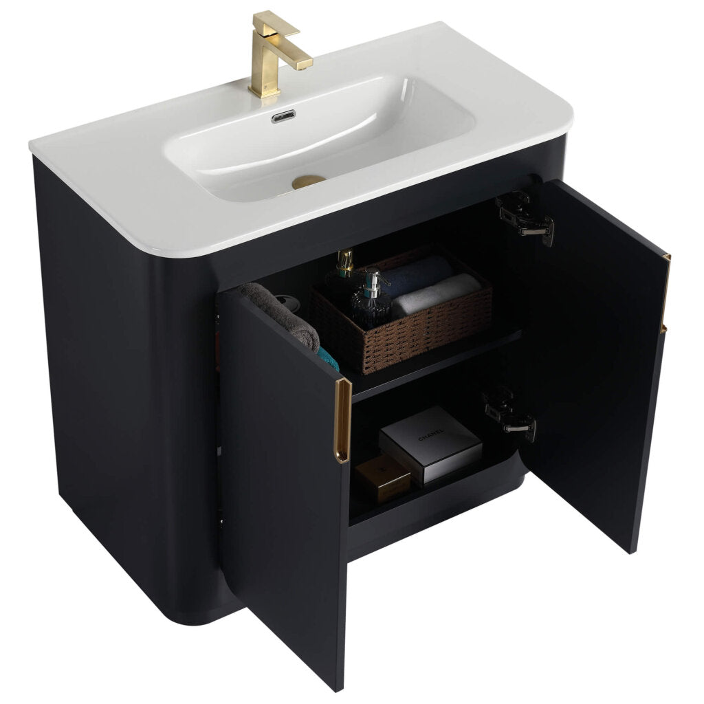 The Shireplace 36 Inch Bathroom Vanity With Sink flaunts a black design with a sleek white countertop and a gold faucet. Its open cabinet doors display towels and essentials, combining modern elegance with practical storage.