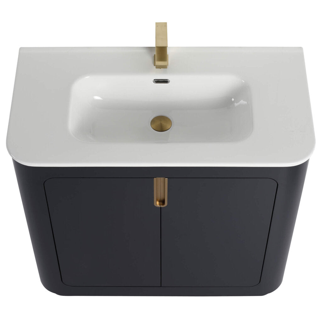Introducing the Shireplace 36 Inch Bathroom Vanity With Sink: a modern masterpiece featuring a sleek, white rectangular basin, gold faucet and drain. Set atop a dark cabinet with two doors and central gold handle, it flawlessly blends style with functionality.