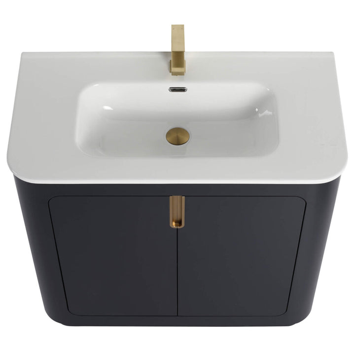Introducing the Shireplace 36 Inch Bathroom Vanity With Sink: a modern masterpiece featuring a sleek, white rectangular basin, gold faucet and drain. Set atop a dark cabinet with two doors and central gold handle, it flawlessly blends style with functionality.