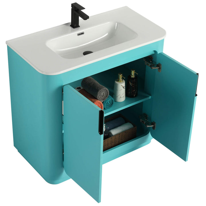 The Shireplace 36 Inch Bathroom Vanity With Sink adds a modern touch with its turquoise finish and open cabinet design, showcasing a glossy white sink and sleek black faucet. Inside, shelves are neatly arranged with rolled towels, bottles, and a woven basket.