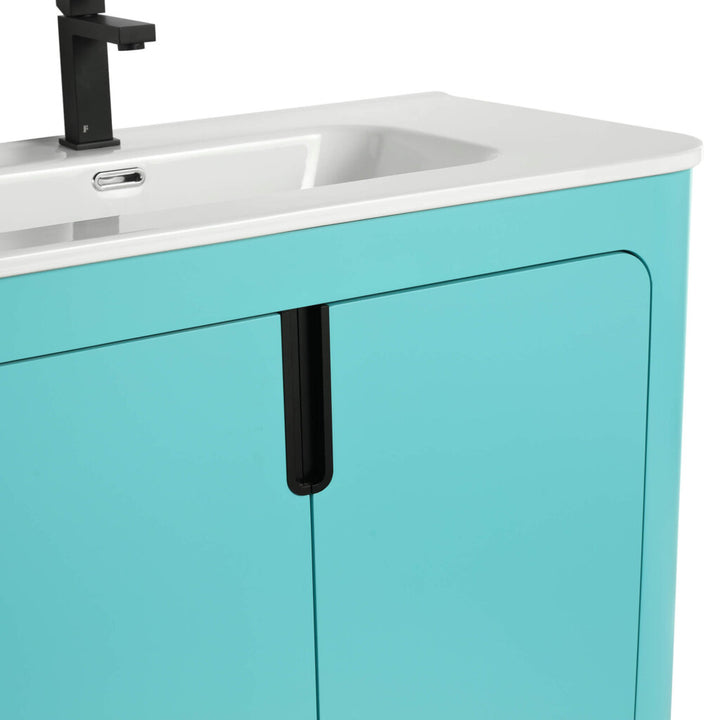 A close-up of the Shireplace 36 Inch Bathroom Vanity With Sink reveals its glossy teal finish and sleek black handle, featuring a minimalist design with a white basin and black faucet, perfect for adding elegance to any contemporary bathroom.