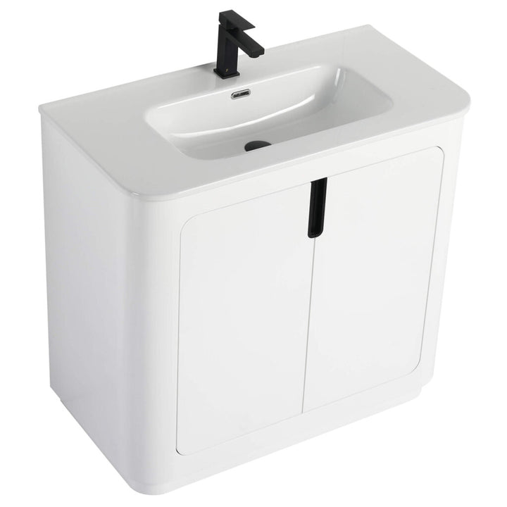The Shireplace 36 Inch Bathroom Vanity With Sink showcases a sleek white vanity with an integrated sink and stylish black faucet. Its modern, minimalistic design includes a cabinet below with dual closed doors and a central black handle.