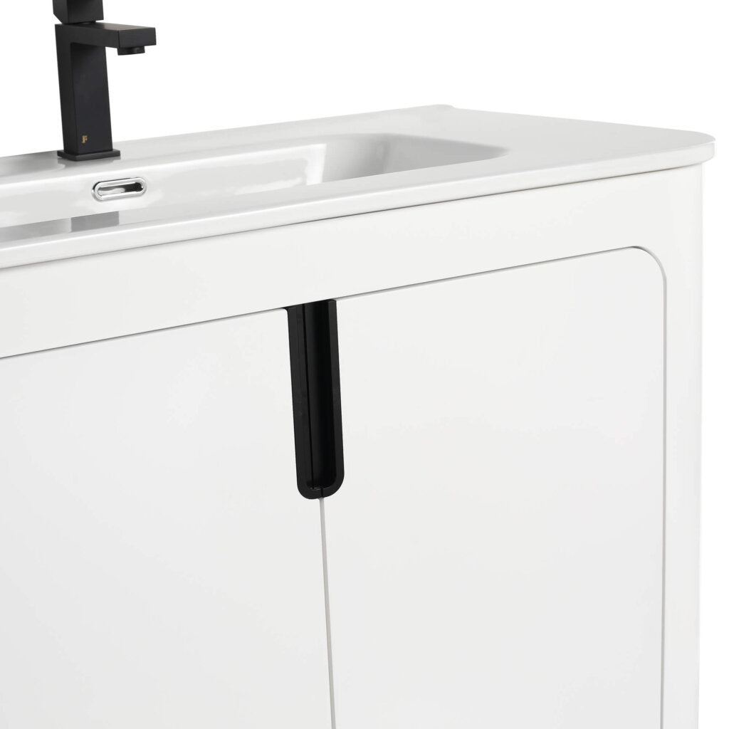 A close-up of the Shireplace 36 Inch Bathroom Vanity With Sink reveals a modern design with sleek, minimalist cabinet doors and a smooth countertop, complemented by a black faucet that beautifully frames the rectangular sink.