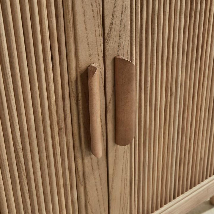 Close-up of the Liora 30 Inch Bathroom Vanity’s two wooden doors, featuring vertical grooves and modern angled handles in a natural light wood finish.