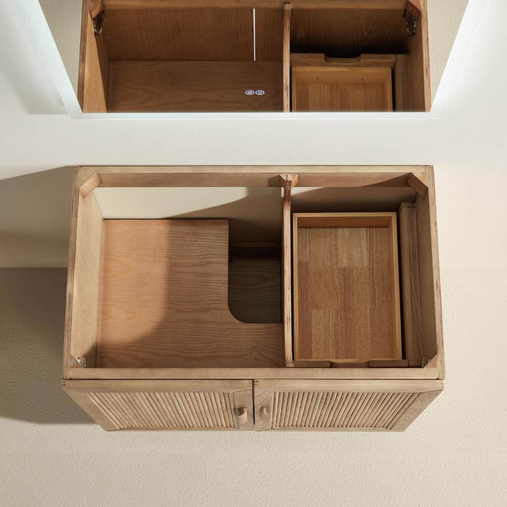 The Liora 30 Inch Bathroom Vanity features an open top view with internal compartments, including a rectangular tray and a plumbing cut-out section. The doors have vertical grooves for added style.