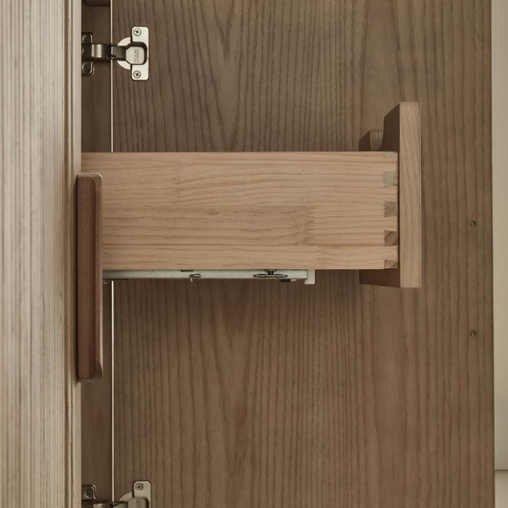 A close-up view of the Liora 30 Inch Bathroom Vanity drawer, partially pulled out to reveal dovetail joints and a metal sliding mechanism inside the cabinet.