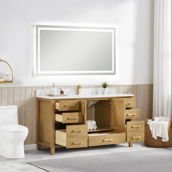 A bright, modern bathroom features the Basel 60 Inch Single Bathroom Vanity with open drawers and shelves, a large lighted mirror, white countertop, toilet, towel basket, and simple decor illuminated by natural light.