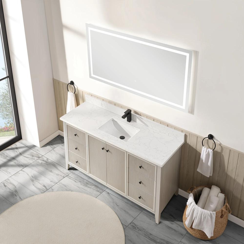 The Torino 60 Inch Single Bathroom Vanity features a white marble countertop, rectangular sink, and black faucet beneath a large illuminated mirror. Black towel rings hold towels while a basket of rolled towels rests on the gray tiled floor.