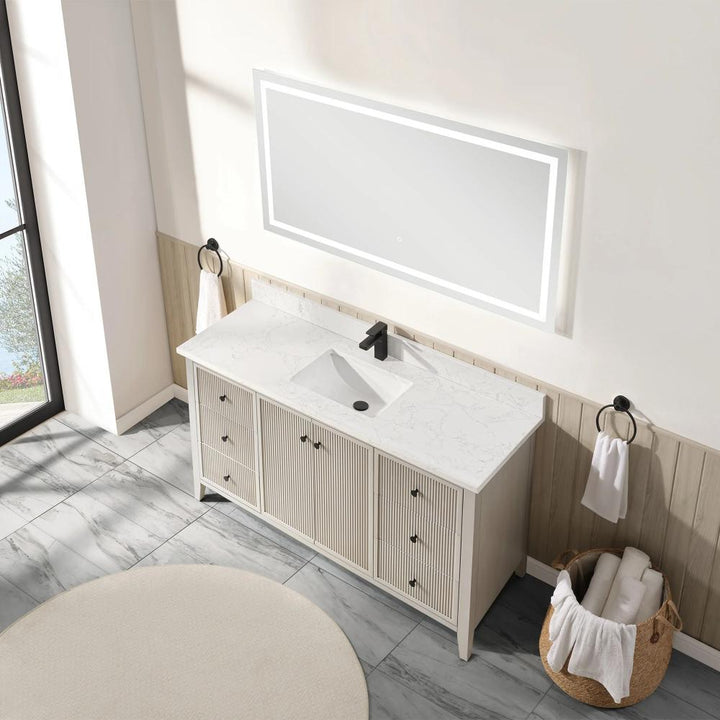 The Torino 60 Inch Single Bathroom Vanity features a white marble countertop, rectangular sink, and black faucet beneath a large illuminated mirror. Black towel rings hold towels while a basket of rolled towels rests on the gray tiled floor.