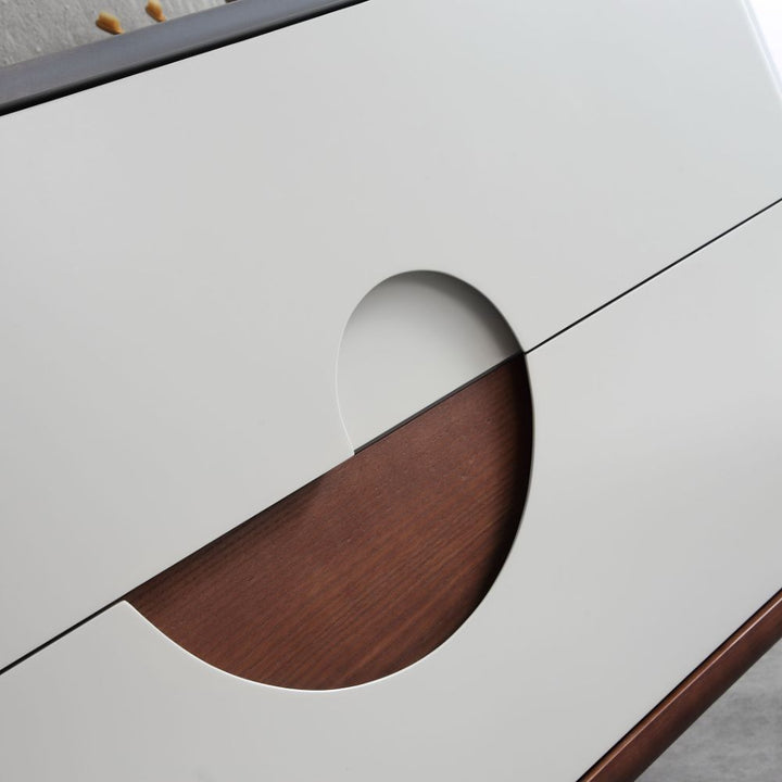 Close-up of the Burano 30 inch Beige Freestanding Bathroom Vanity, showcasing two white doors with semi-circular cutouts forming a full circle when closed and revealing part of the brown wood interior.