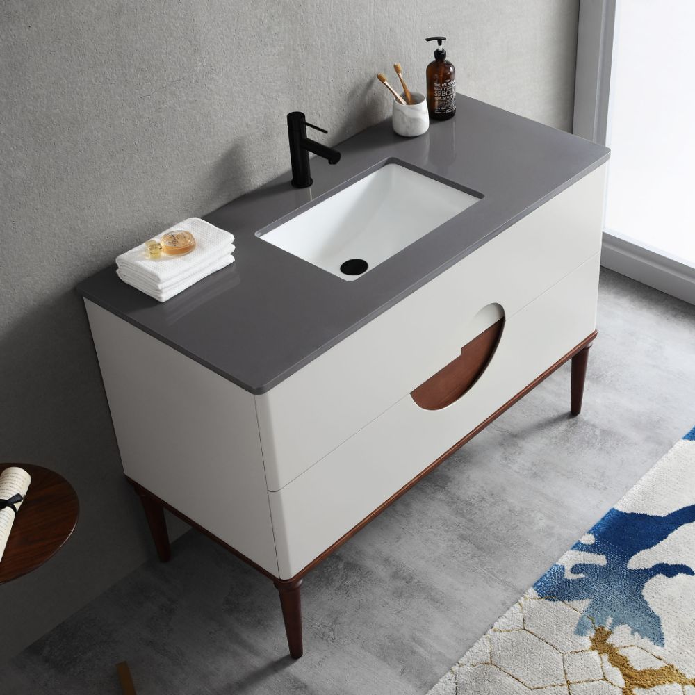 The Burano 48 inch Beige Freestanding Bathroom Vanity features a modern beige countertop, rectangular sink, black faucet, soap dispenser, and white towels. With two drawers and wooden legs, it complements any neutral bathroom decor.