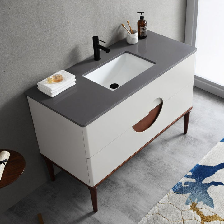 The Burano 48 inch Beige Freestanding Bathroom Vanity features a modern beige countertop, rectangular sink, black faucet, soap dispenser, and white towels. With two drawers and wooden legs, it complements any neutral bathroom decor.