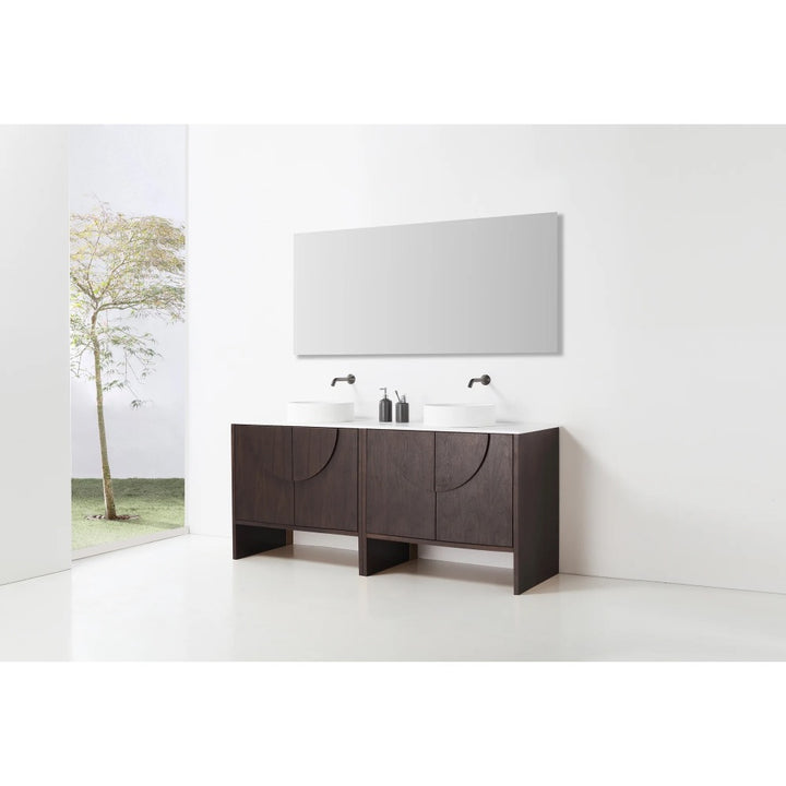 Minimalist bathroom with a Celle 72 Inch Double Bathroom Vanity With Vessel Sinks, two black faucets, a large rectangular mirror above, and a window with leafy tree views. White walls and floor create a clean, modern look.