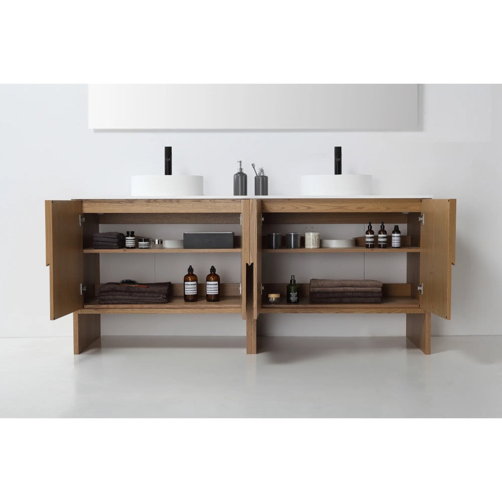 The Celle 72 Inch Double Bathroom Vanity With Vessel Sinks features open wooden cabinets for neatly folded towels, bottles, jars, and bath accessories, topped with two white vessel sinks and soap dispensers.