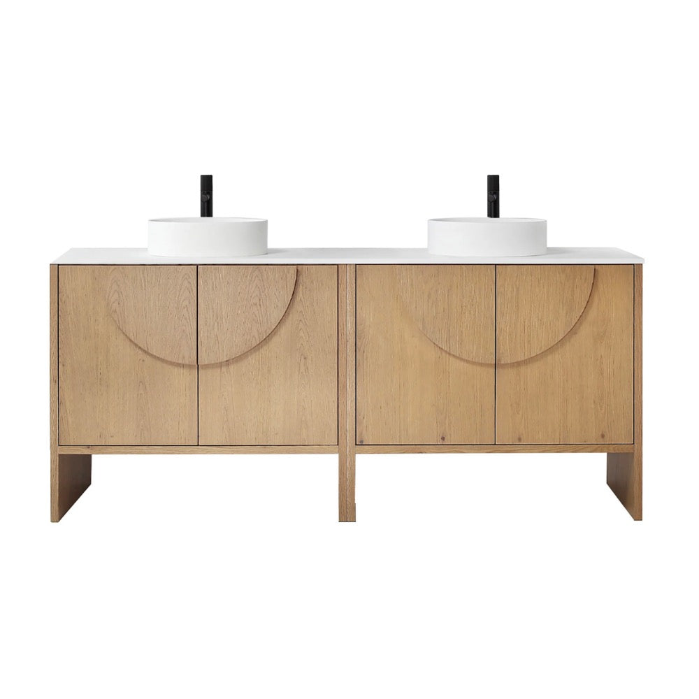 The Celle 72 Inch Double Bathroom Vanity With Vessel Sinks features a light wood finish, white countertop, two round vessel sinks, black faucets, and minimalist cabinet doors with circular groove designs.