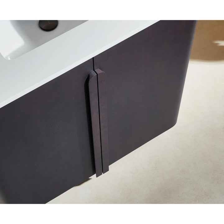 Close-up of the Parma 36 Inch Bathroom Vanity With Top, showing its dark cabinet doors, vertical handles, and white sink set on a light-colored floor.