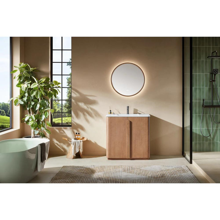 Modern bathroom featuring the Parma 36 Inch Bathroom Vanity With Top, a round backlit mirror above the wooden cabinet, large window, potted plant, freestanding tub, glass shower, and a neutral rug on the floor.