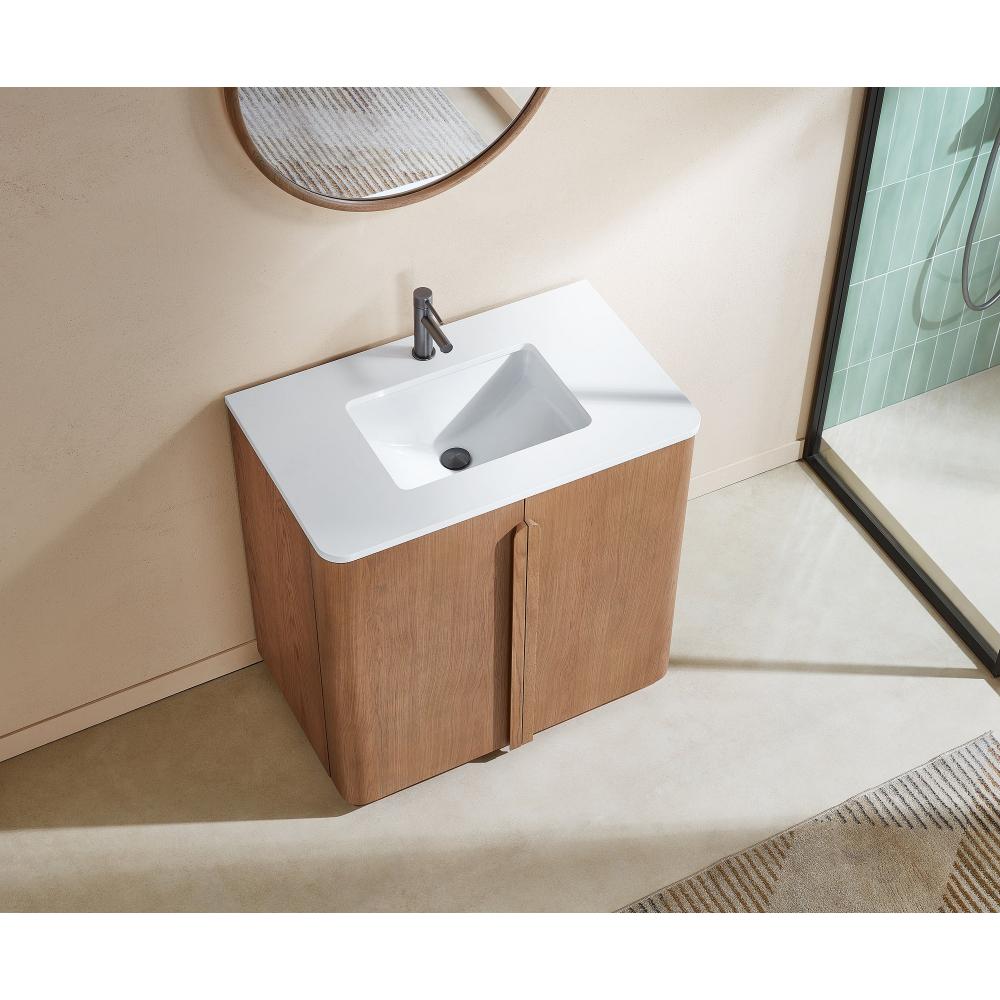 The Parma 36 Inch Bathroom Vanity With Top includes a white rectangular sink, wooden cabinet, single faucet, round mirror above, beige floor beneath, and a glass shower enclosure visible to the right.