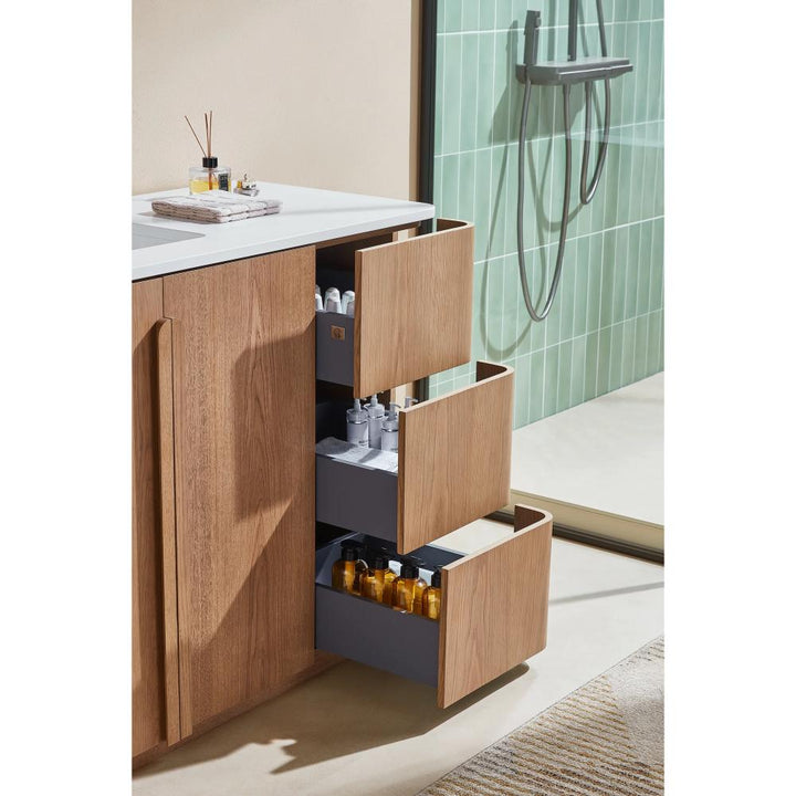 A Parma 48 Inch Bathroom Vanity With Top includes three open gray drawers holding bottles and toiletries. A glass shower with green tile walls is on the right, and a beige rug lies on the floor.