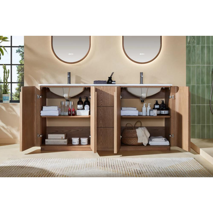 A Parma 72 Inch Double Bathroom Vanity With Top stands in a modern, beige bathroom, its open cabinet doors revealing neatly organized towels, baskets, bottles, and toiletries beneath two sinks and mirrors.