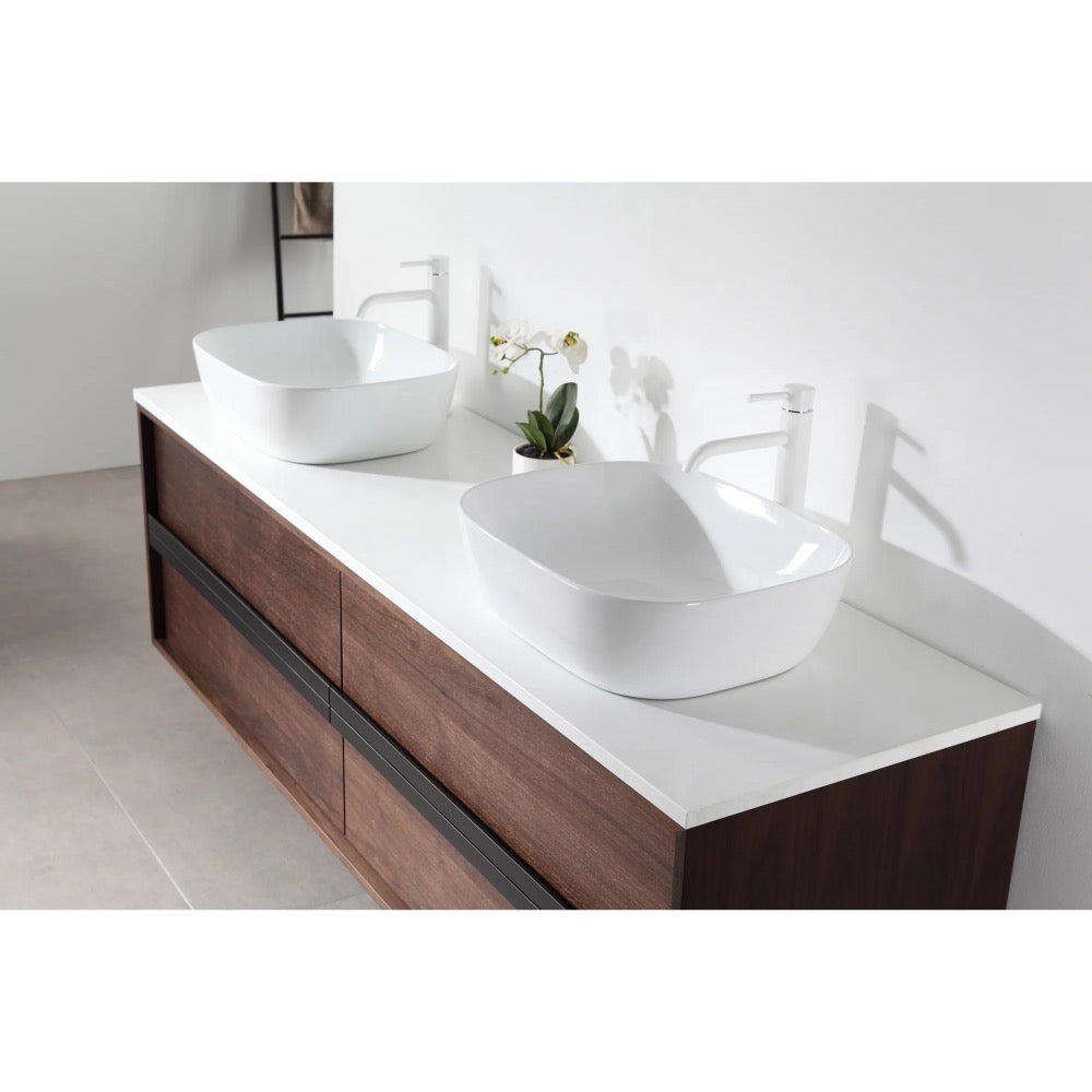 The Sintra 72 Inch Wall Mount Vanity with Double Vessel Sinks offers a white countertop, two rectangular vessel sinks, white faucets, a potted orchid accent, and bold dark wood with black drawer fronts.