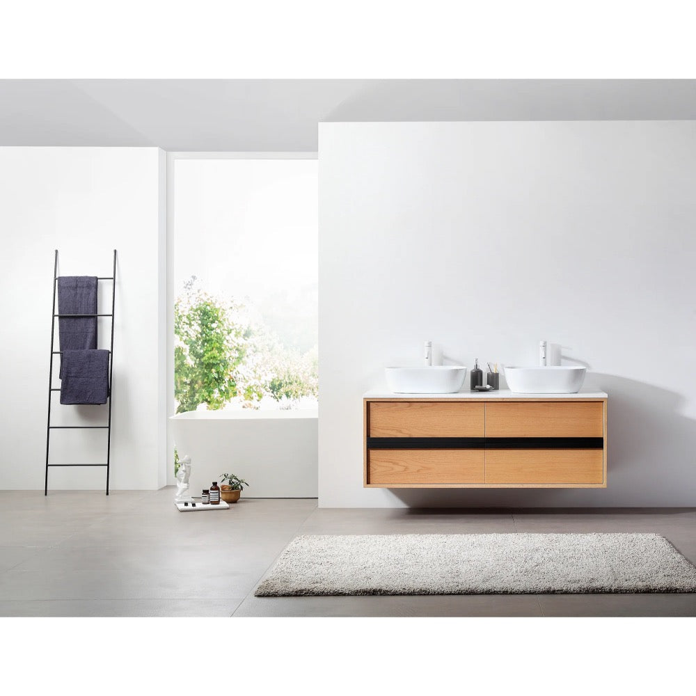 A modern bathroom with the Sintra 55 Inch Wall Mount Vanity with Double Vessel Sinks, a large white rug, a ladder shelf holding dark towels, and a window revealing lush green views.