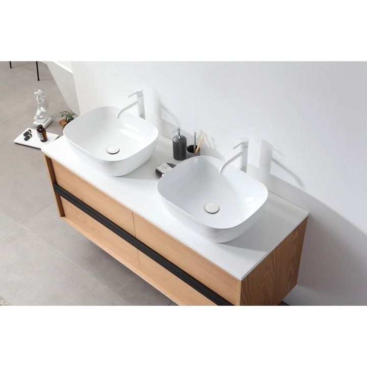 The Sintra 55 Inch Wall Mount Vanity with Double Vessel Sinks includes a light wood cabinet, white countertop, two square vessel sinks, white faucets, and minimal accessories for a clean, modern look.