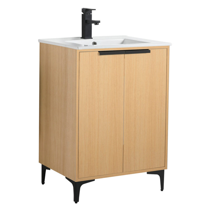 Introducing the Wilmington 24 Inch Bathroom Vanity With Sink, a minimalist wooden design featuring a white countertop and black faucet. It has two doors with black handles and stands on four sleek legs, adding a modern touch to your bathroom decor.