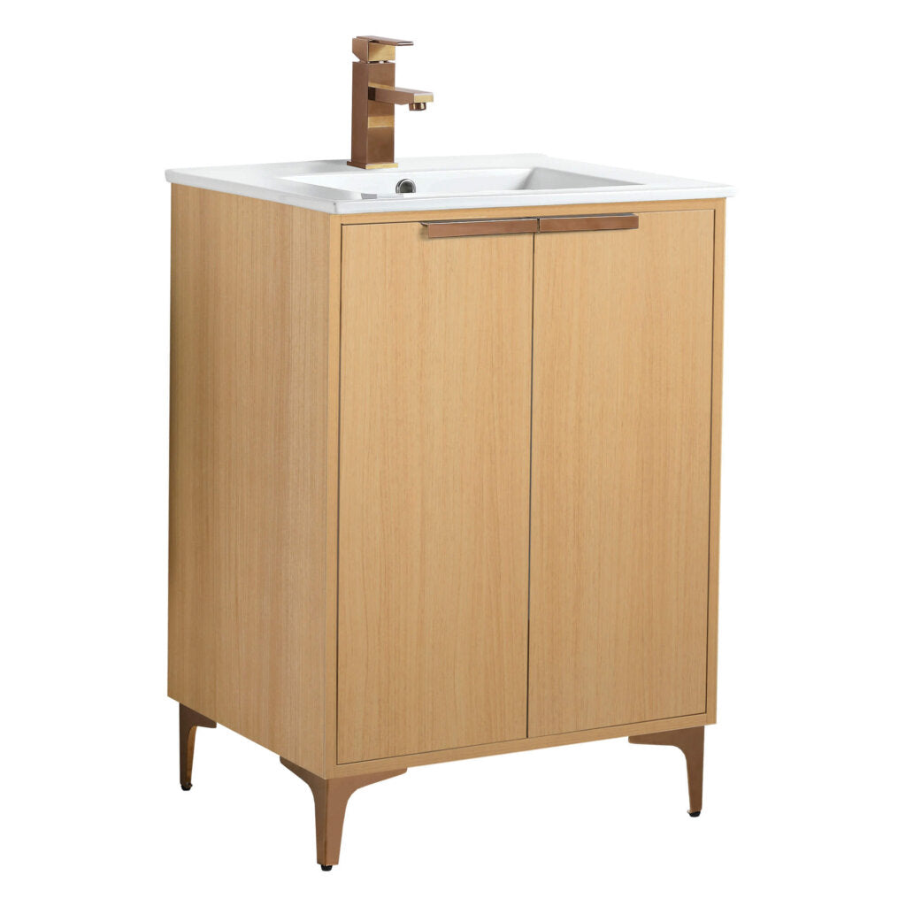 The Wilmington 24 Inch Bathroom Vanity With Sink features a wooden finish, rectangular white basin, and modern brass faucet. It includes two cabinet doors and stands on four slender legs, offering a minimalist and contemporary design.