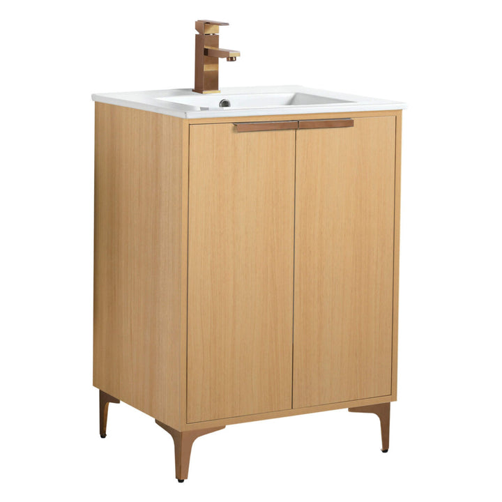 The Wilmington 24 Inch Bathroom Vanity With Sink features a wooden finish, rectangular white basin, and modern brass faucet. It includes two cabinet doors and stands on four slender legs, offering a minimalist and contemporary design.