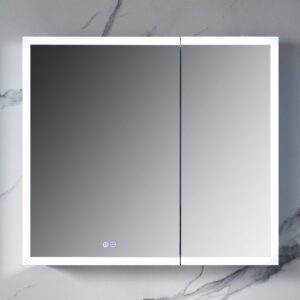 The Capella 36 inch LED Medicine Cabinet is a modern square piece featuring mirrored doors and integrated LED lights. It complements marble-patterned walls and has touch-sensitive mirror controls for easy use.